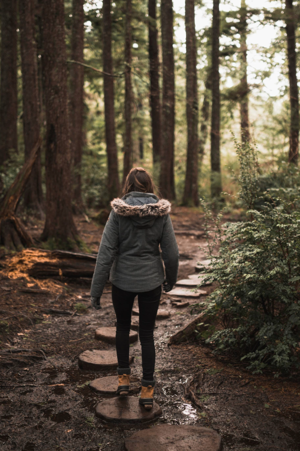 Woman walking along a path in the woods